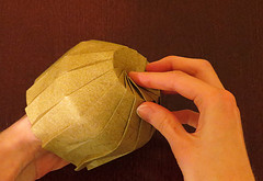 Mãos construindo um origami.